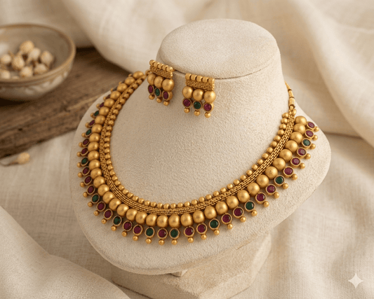 Traditional Matte Gold Beaded Necklace Set with Ruby & Green Stones - Tara Dhara